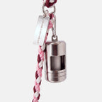 A silver dog poop bag holder attached to a pink, burgundy, and white braided cord leash, featuring a silver metal tag engraved with 'JAMIE DOGWEAR'.
